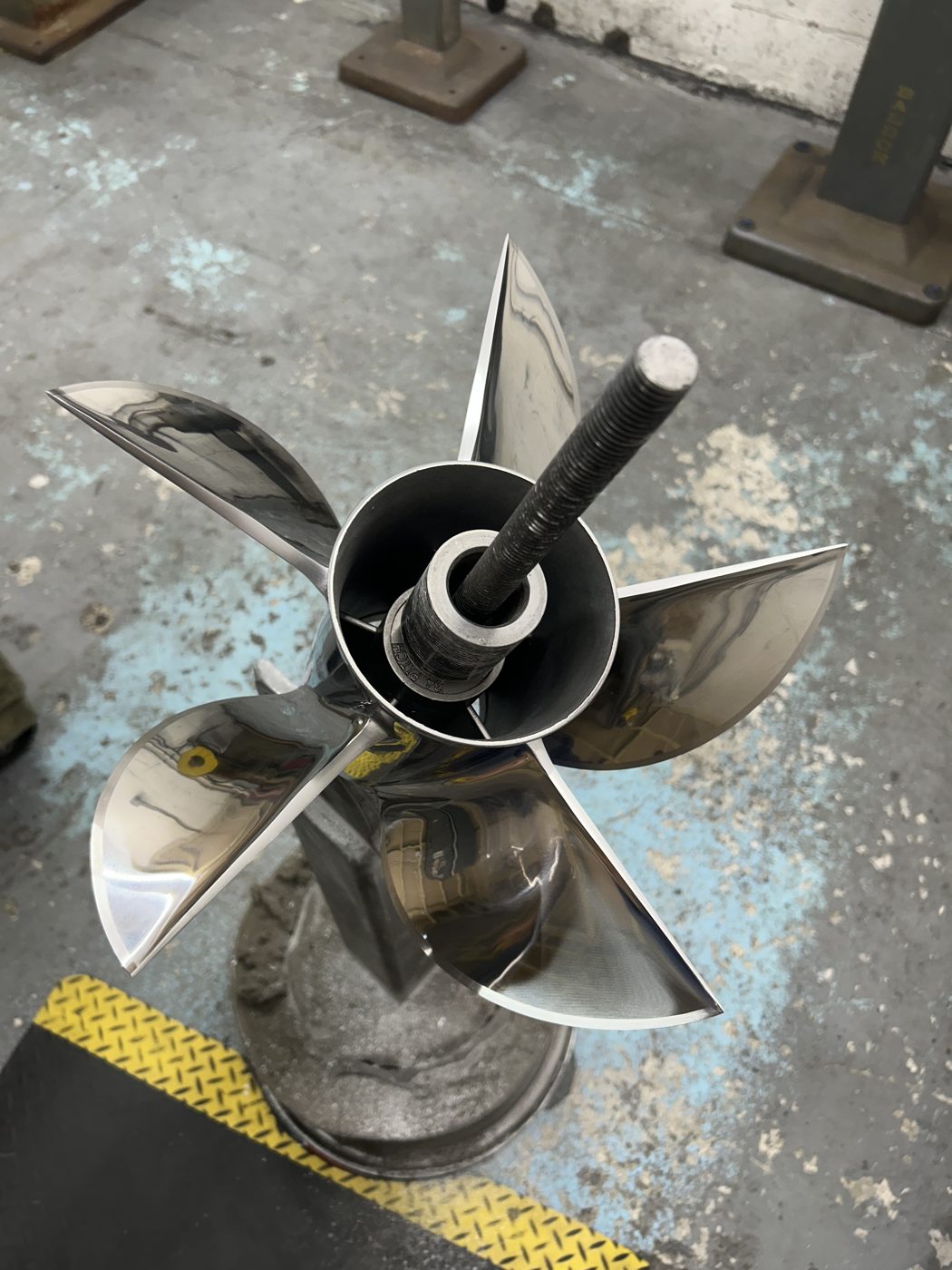 Polished stainless steel five-blade propeller after repair and finishing at PropWorx